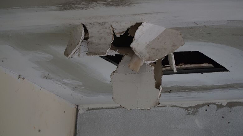 Damaged ceiling with collapsed drywall from storm-related water intrusion